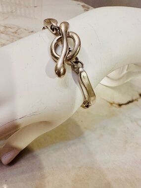 Robert Lee Morris Silver bracelet with a unique design featuring a twisted knot